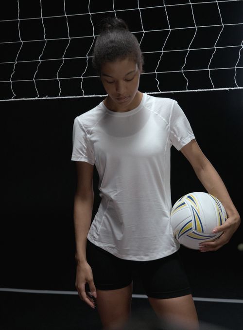 Free Focused black woman athlete holding a volleyball indoors. Studio shoot. Stock Photo