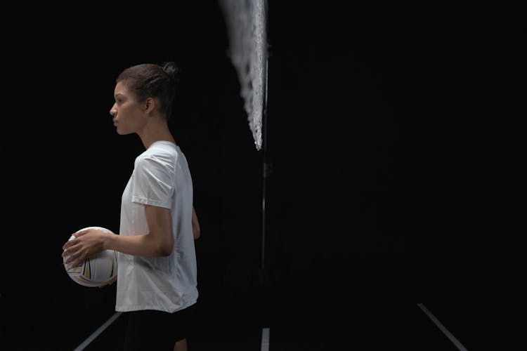 A Woman Holding A Volleyball