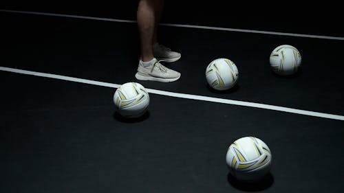 Free Person in White Nike Soccer Shoes Standing on Black Floor Stock Photo
