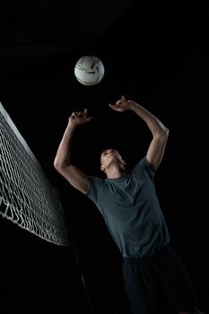Athlete in action, leaping for a volleyball spike during an intense match.