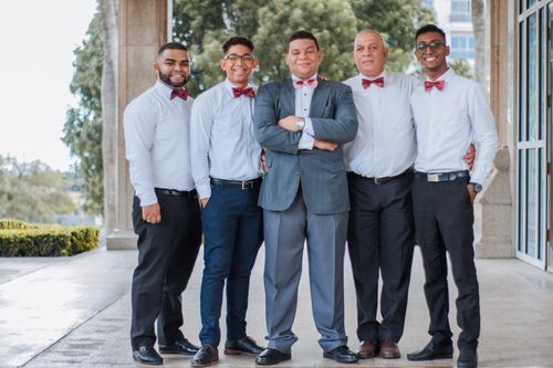 Free A group of men in formal attire posing together, showcasing togetherness and celebration. Stock Photo