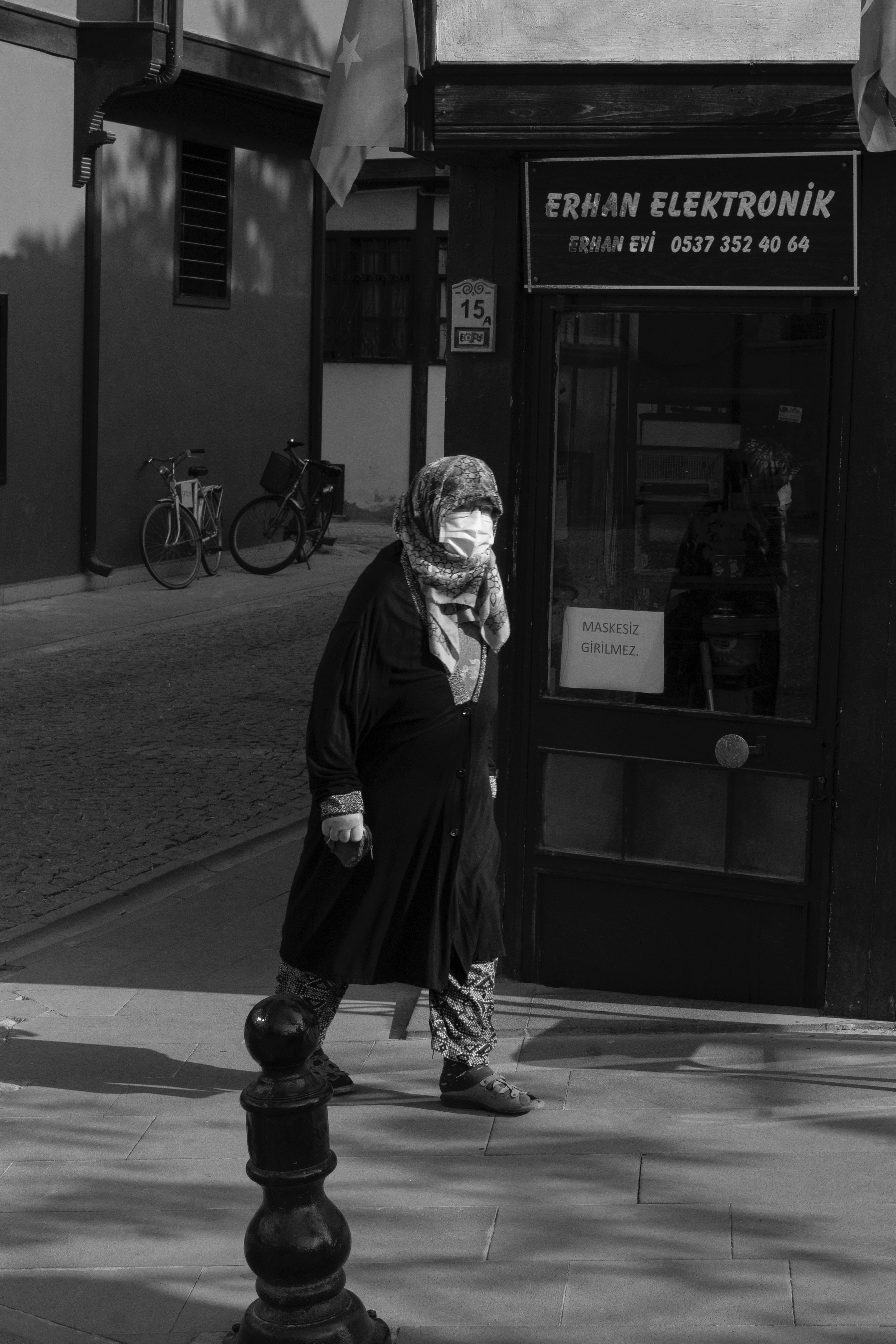 Black and white street photo of a woman walking in Turkey.