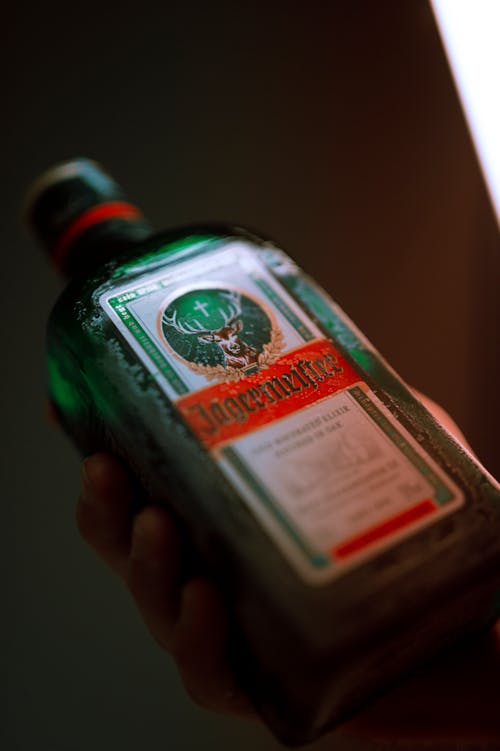 Close-Up Shot of a Person Holding a Beer Bottle