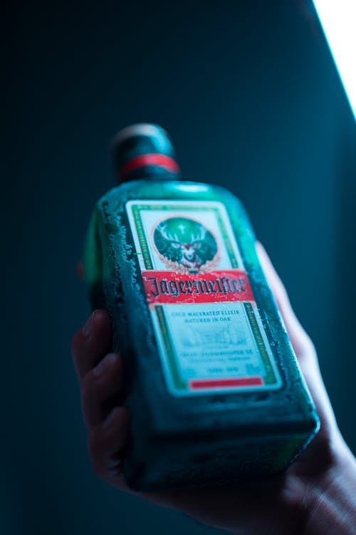Free A Person Holding a Bottle of Jagermeister  Stock Photo