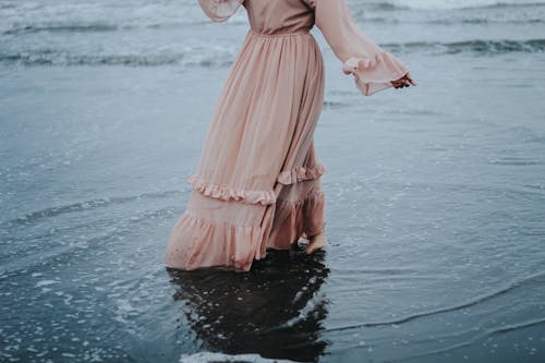 A Shot of Female in Dress Wading in Water 