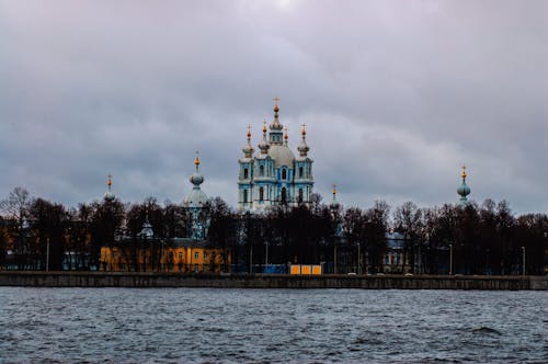 White and Brown Concrete Building Near Body of Water