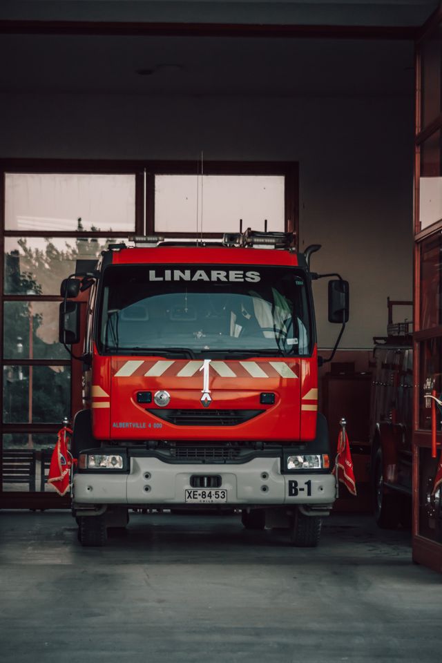 Red fire truck parked in a garage