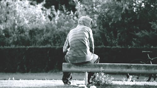 Gray-scale Photo of Person Wearing Stripe Hoodie