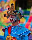 Man in Blue and Red Traditional Dress Wearing Gold Crown
