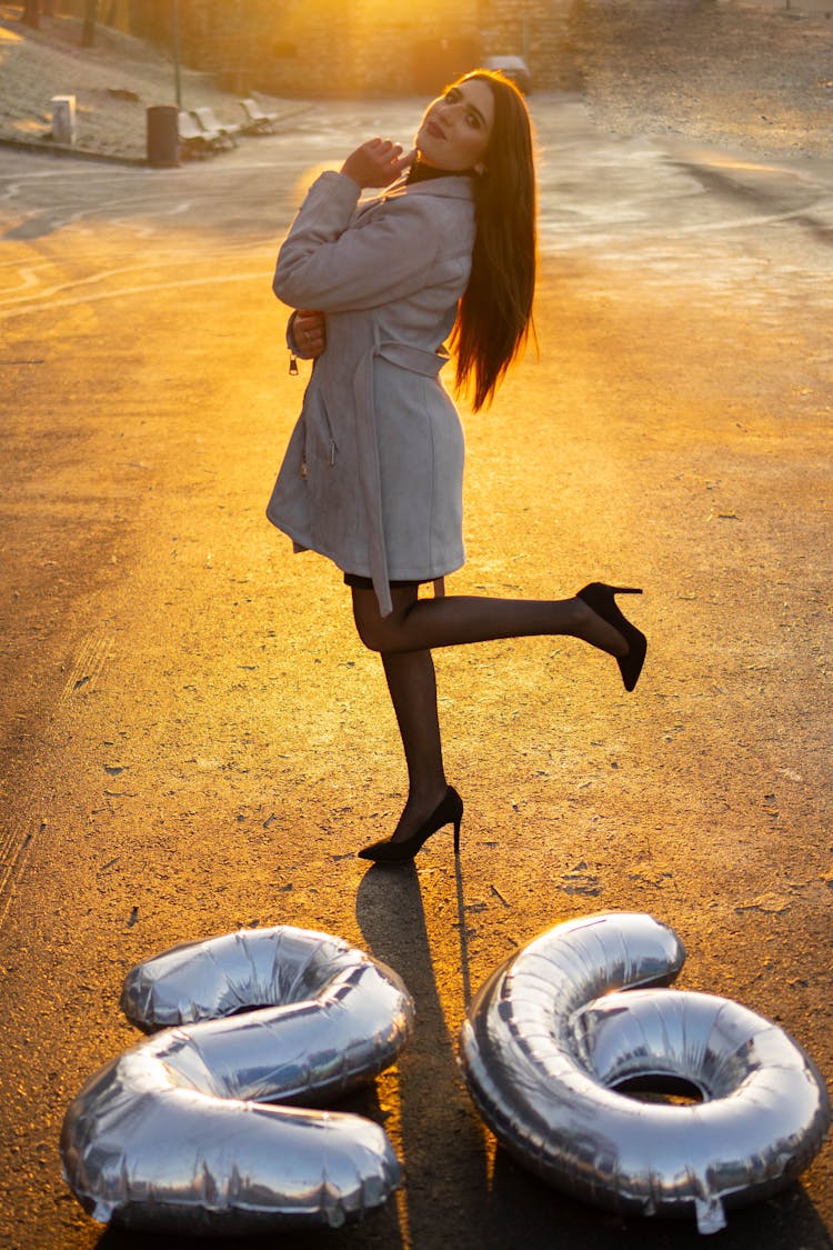 Woman Wearing High Heels Posing On A Footpath With Inflated Digits