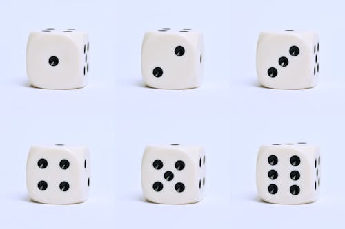 Close-Up Shot of Dice on a White Surface