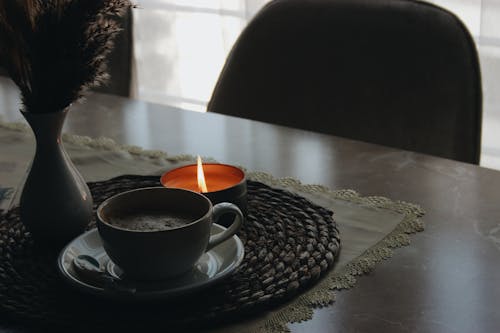 Coffee and Candle on Table