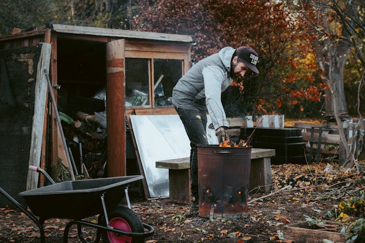 Man Tiding Up Mess In Backyard 