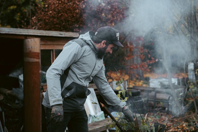 Man Burning Leaves In The Backyard 