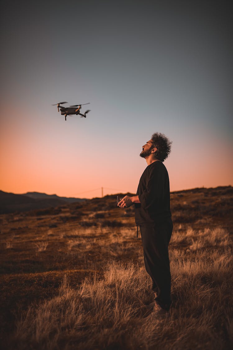 A Man Flying A Drone Machine