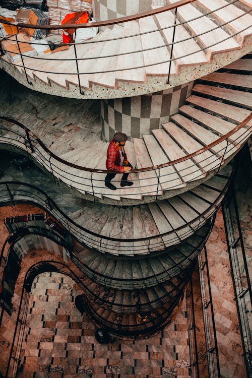 Free Man Plaid Shirt Walking Up The Staircase Stock Photo