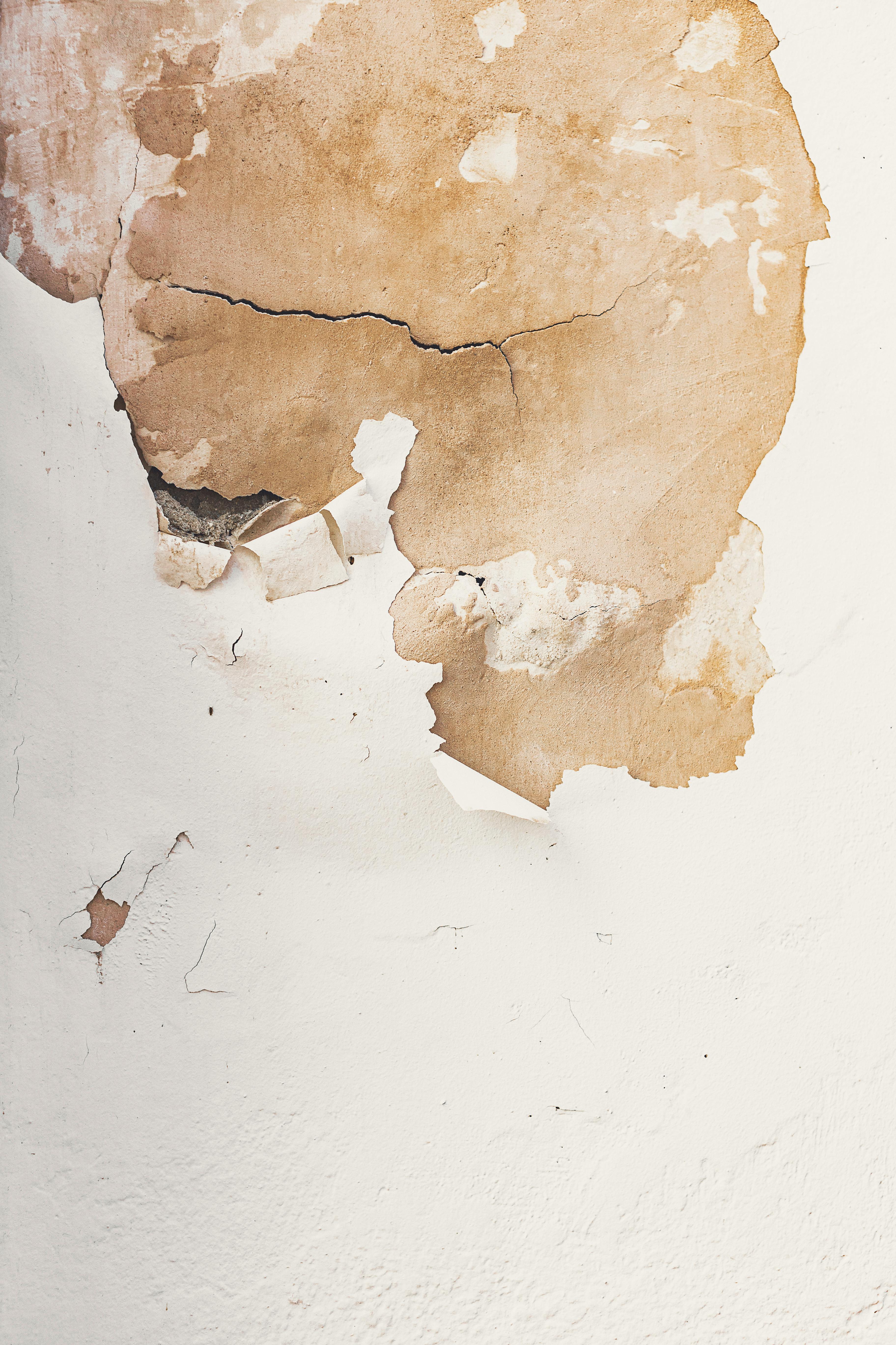 Close-up of an old wall with cracked and peeling paint in Málaga, Spain.