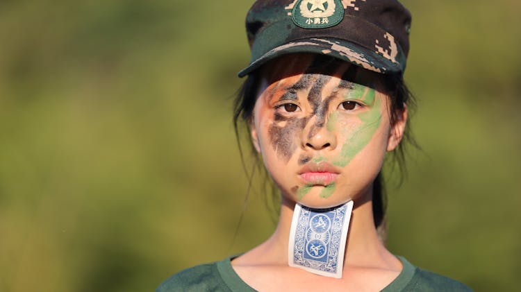 Woman With Painted Face And Card On Neck