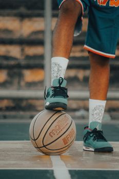 Close-up of a basketball player's legs and shoes on the court in Nigeria.