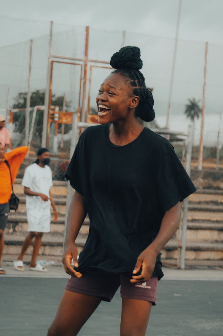 A Woman In Black Crew Neck T-shirt Laughing