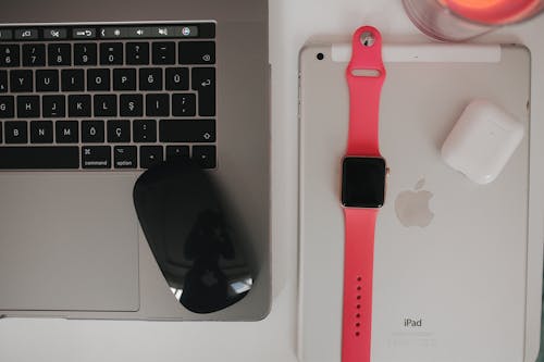 Laptop, Computer Mouse, Smart Watch, Air Pads and Tablet on Desk