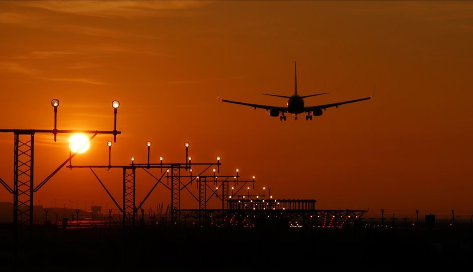 Silhouette of an airplane on final approach at sunset, landing lights glowing against an orange sky. — Photo by Salva F. Ayala on Pexels
