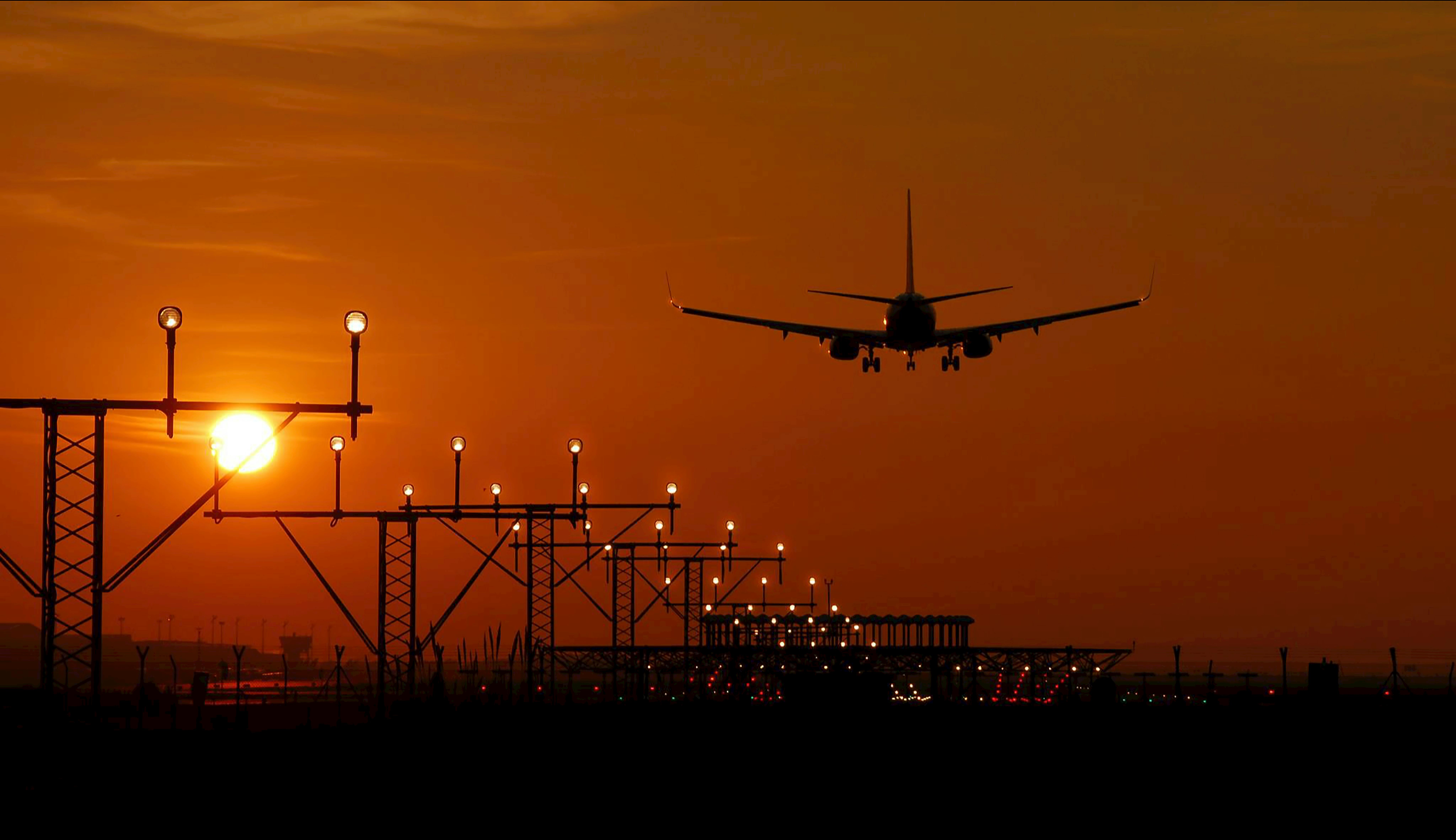 airplane taking off sunset