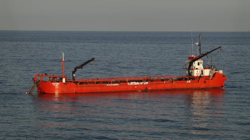 A Red Cargo Ship Sailing