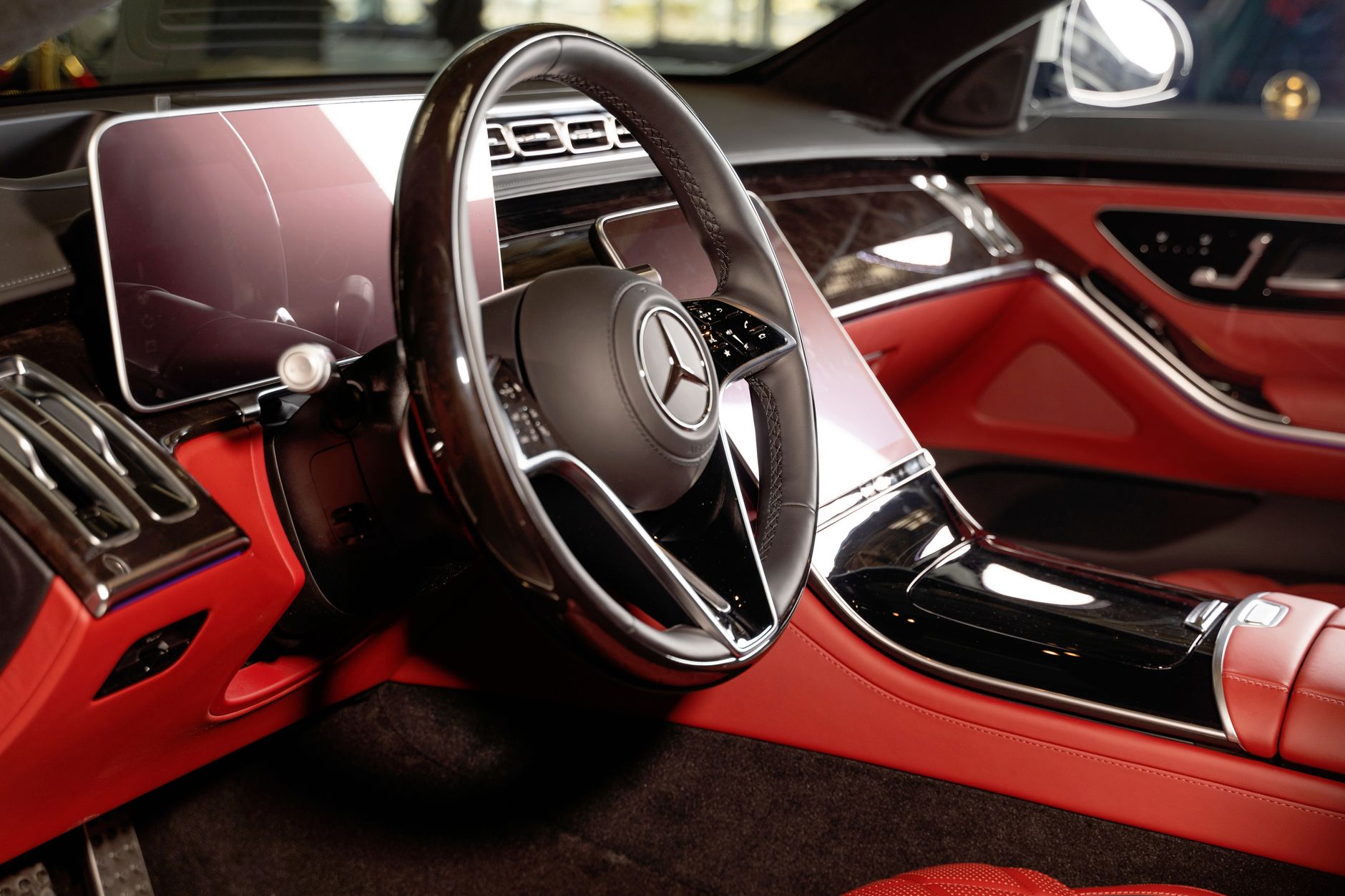 Close-up of a luxury Mercedes-Benz car interior with red leather seats in Dubai.