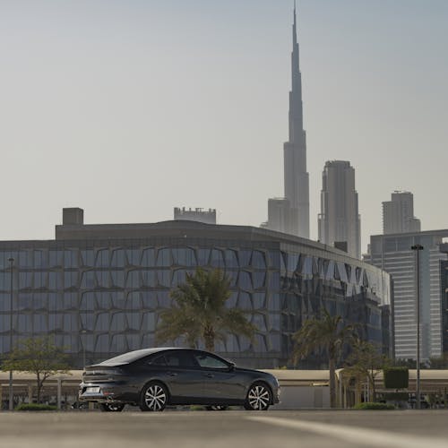A Black Sedan on Road with the Burj Khalifa on the Background