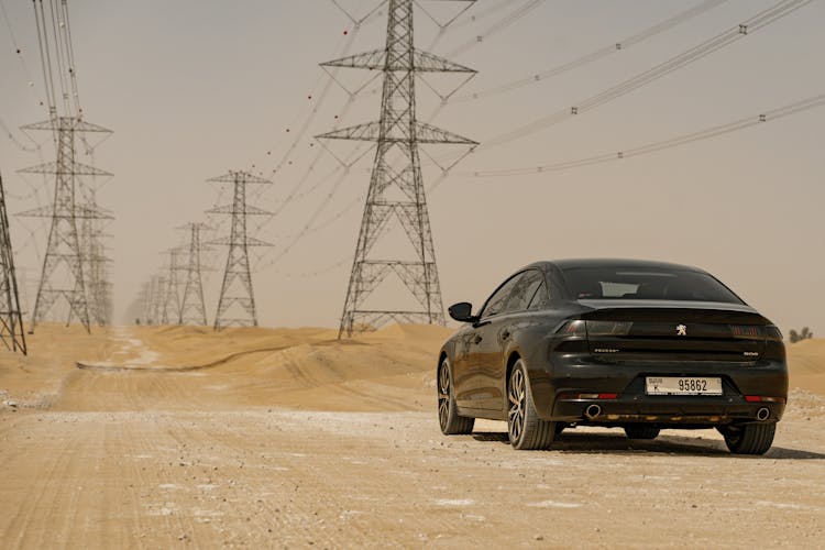 Black Shiny Car Parked On The Desert