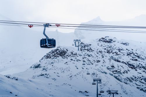 Free Snow-covered mountains with a ski lift in Zermatt, Switzerland offering a serene winter view. Stock Photo