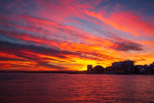 Free Breathtaking sunset over the sea with vibrant orange and pink clouds in Torrevieja, Spain. Stock Photo