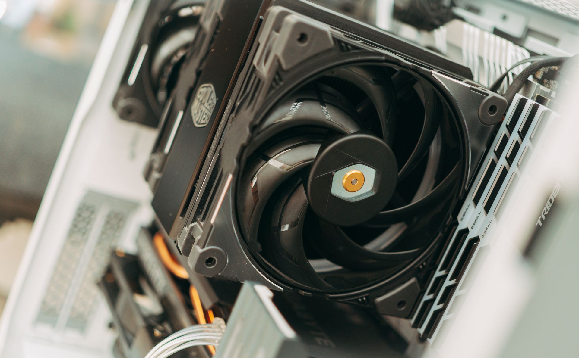 Detailed shot of a computer cooling fan within a desktop PC, showcasing intricate design and machinery.