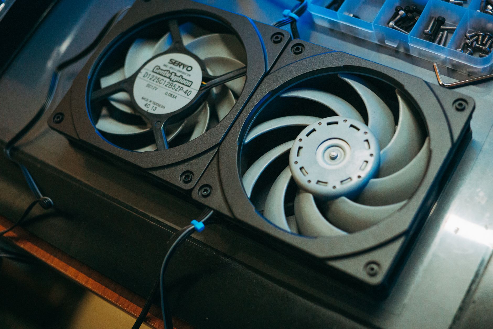 Pair of computer cooling fans on a metal surface for heat dissipation.