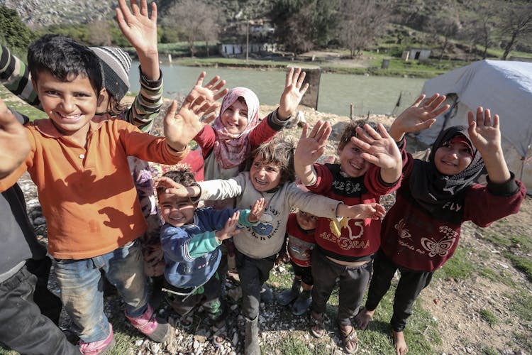 Group Of Children Waving Together