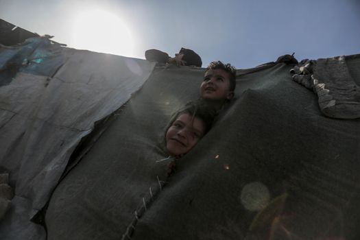 Kids Peeking Out of a Tent