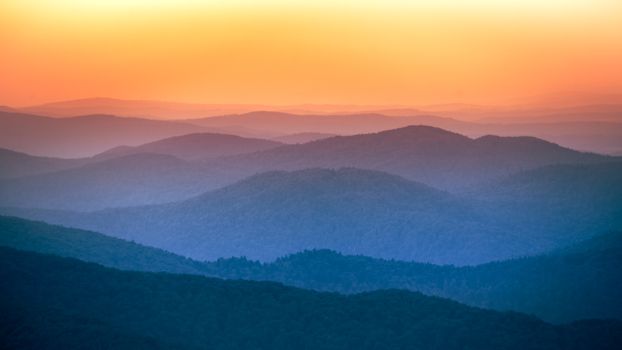 Captivating layers of Bieszczady mountains at sunrise in Poland.
