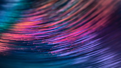 Free Abstract light pattern with vibrant streaks of pink, blue, and purple creating a dynamic flow. Stock Photo