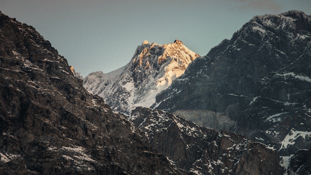 Sunlit snow-capped peaks of the Italian Alps, showcasing natural beauty and rugged mountain landscapes.