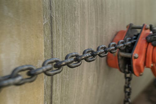 Free Stretched Metal Chain from a Pulley Stock Photo