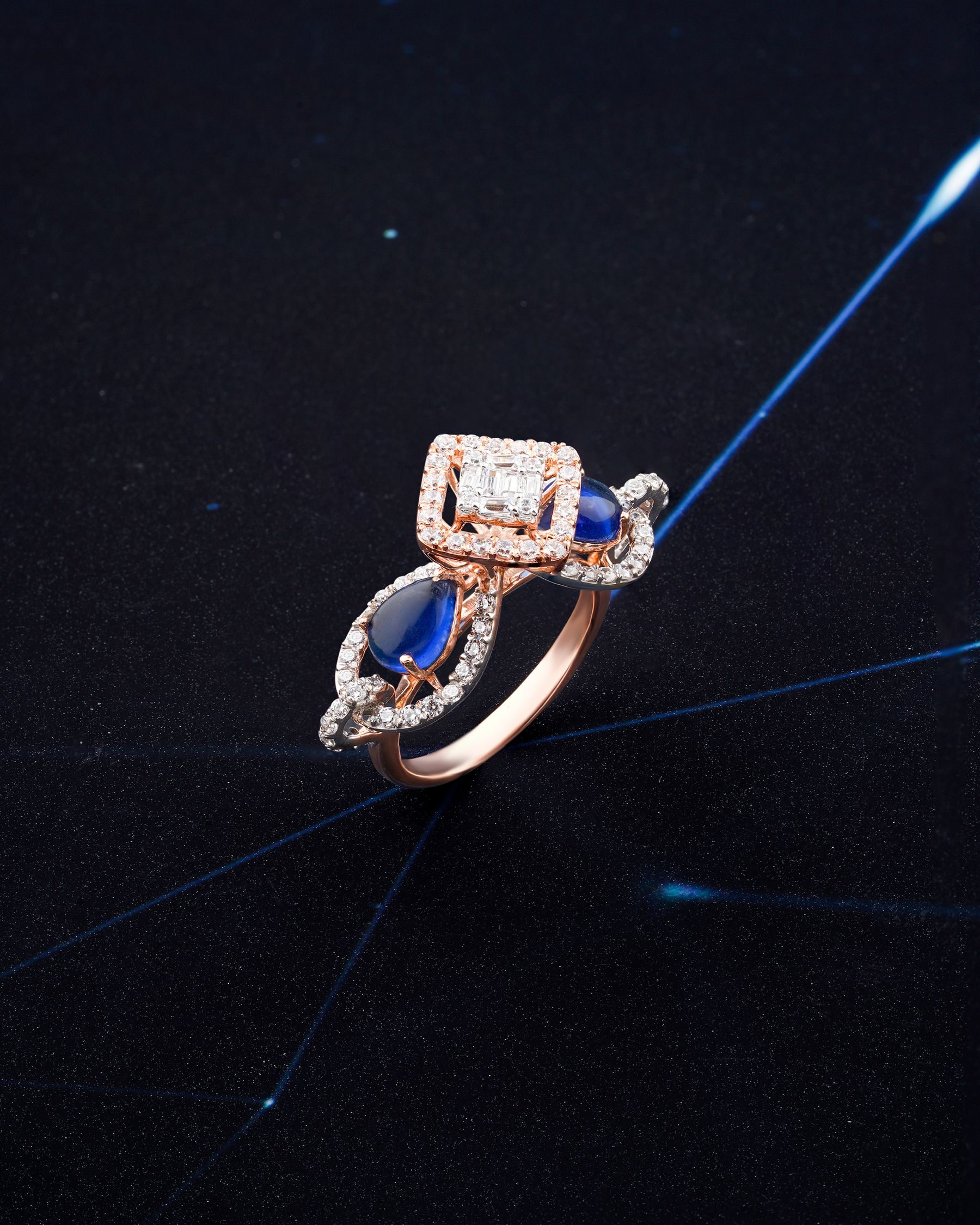 A sapphire and diamond ring under studio light