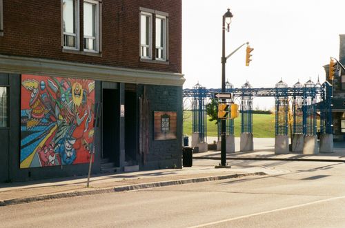 Free A lively urban street corner featuring vibrant graffiti art and architectural elements. Stock Photo