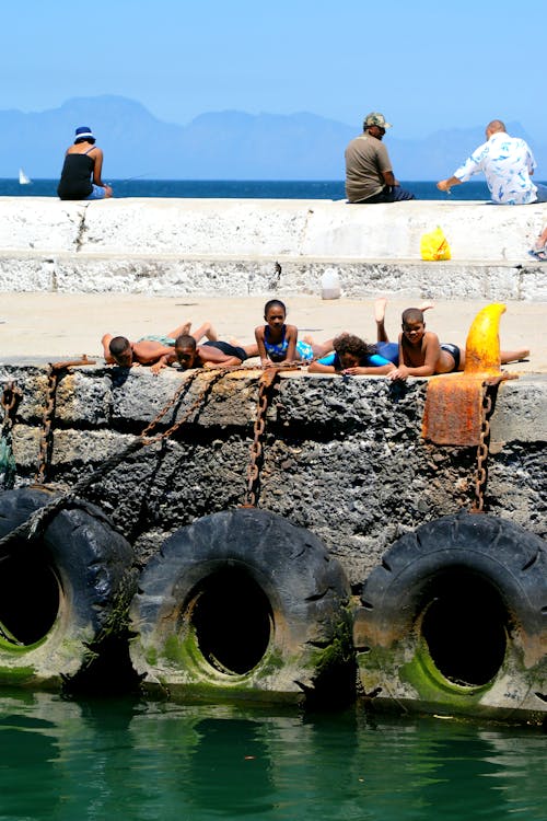 Free stock photo of children bathing, harbour wall
