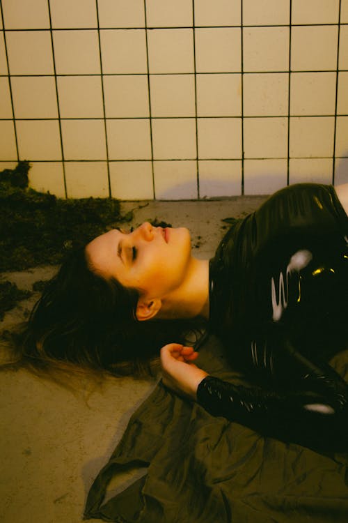 Free Woman in Black Sweatshirt Lying on the Floor Stock Photo