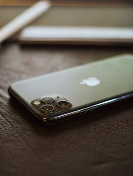 Elegant smartphone resting on a stylish leather table indoors.