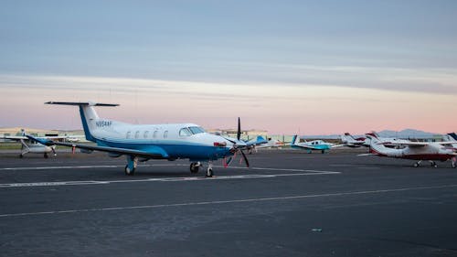 White and Blue Airplane on Airport