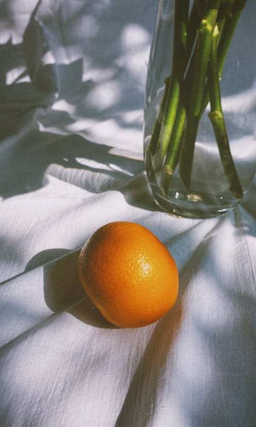 Orange Fruit on Clear Glass Vase