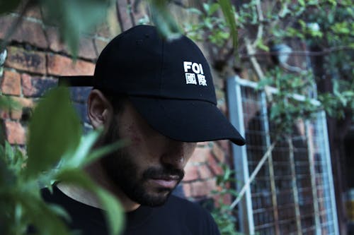 Man Wearing Black Foi Embroidered Fitted Cap