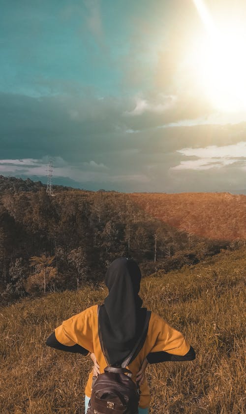 Woman Wearing Black Headdress on Top of Mountain